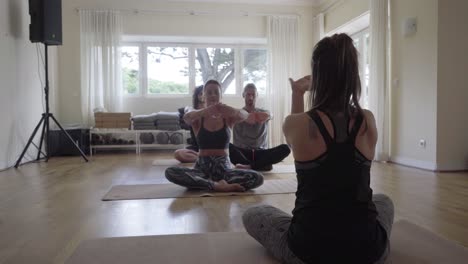 Yoga-group-exercising-indoors